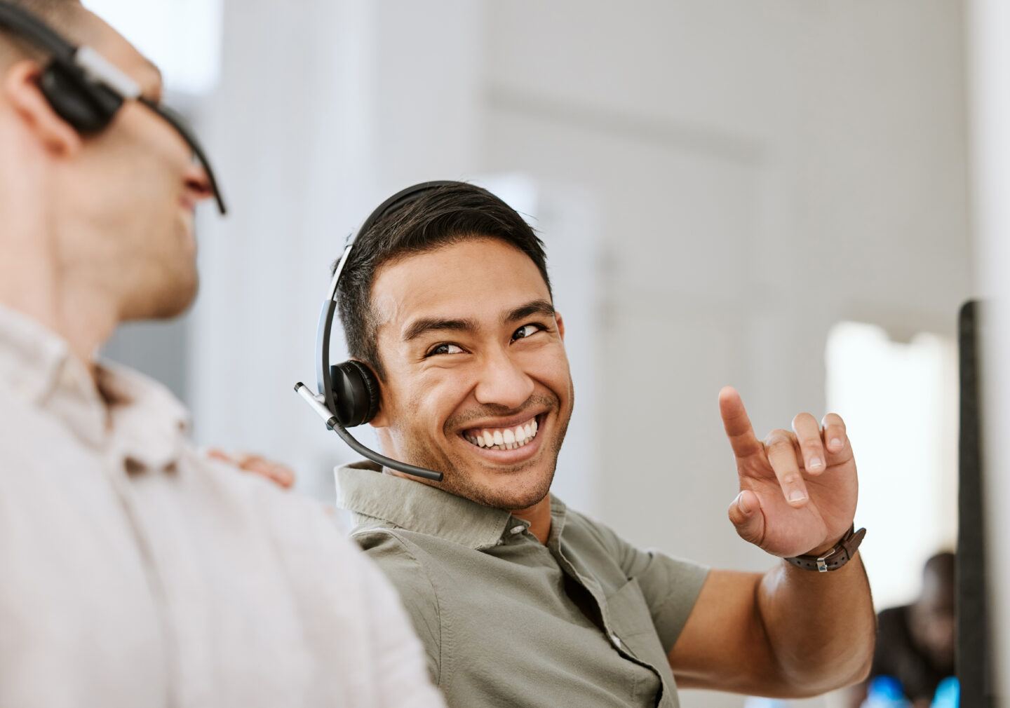 Happy, smiling and laughing call center agent talking to colleague
